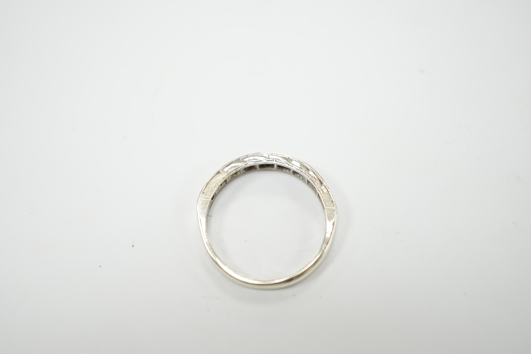 A modern 9ct white hold sapphire and diamond chip set half hoop ring, size N, gross weight 2.1 grams.